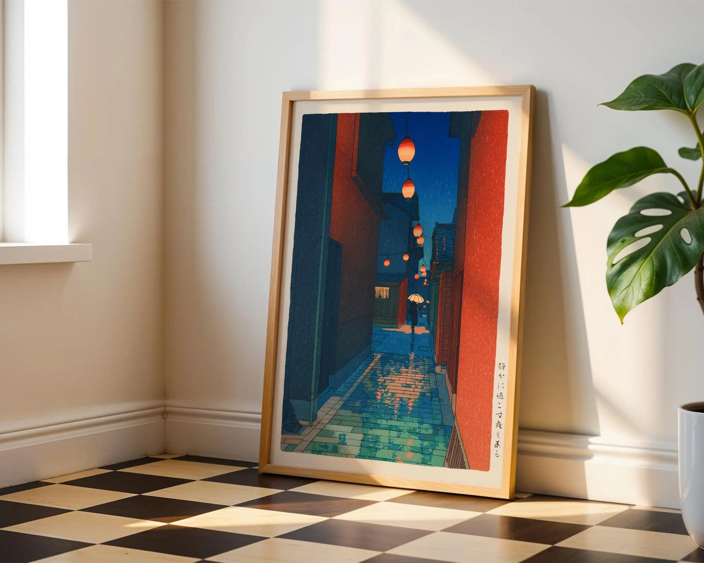 a framed artwork depicting a colorful street scene with lanterns hanging from the buildings.