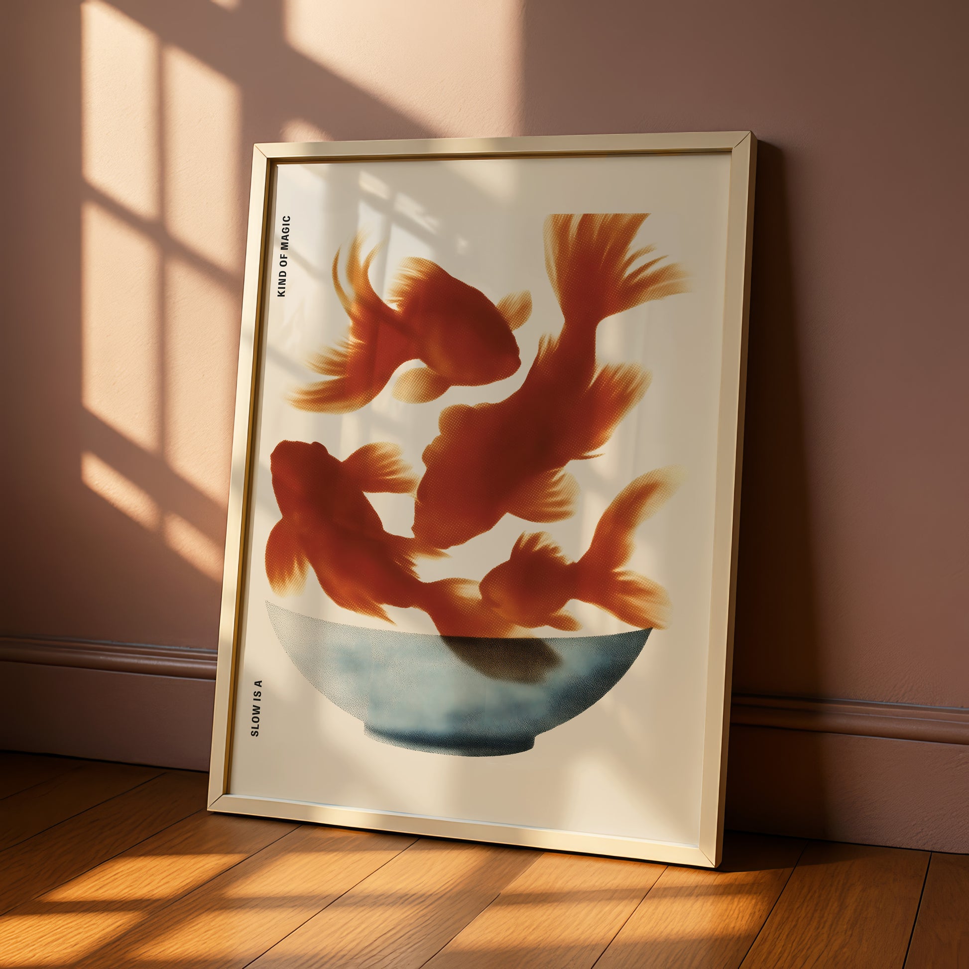 a framed artwork depicting three goldfish swimming in a blue bowl.