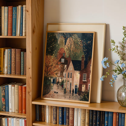 a wooden bookshelf filled with books, a framed painting depicting a quaint village scene, and a vase of blue flowers.