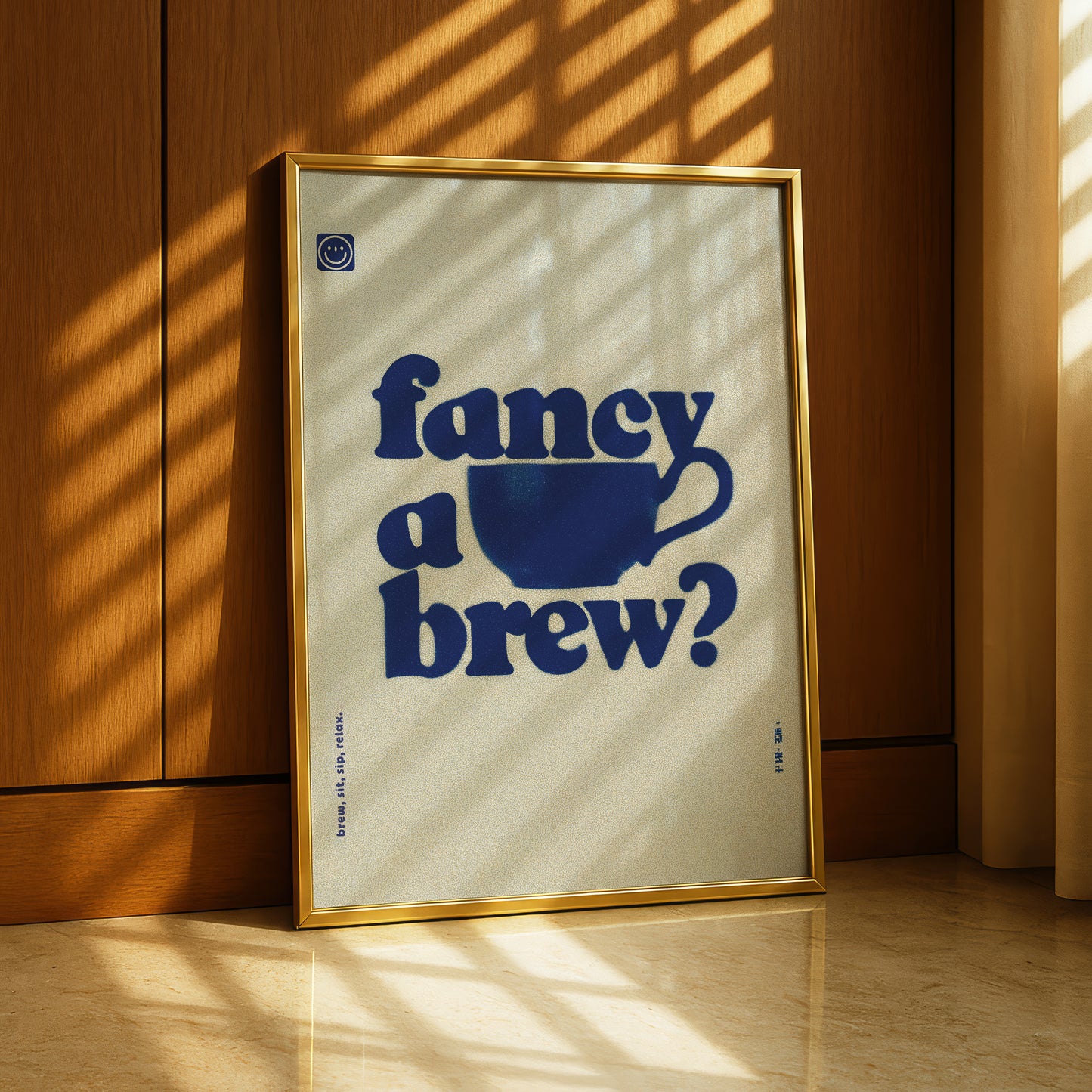 A framed poster with the text "fancy a brew?" displayed prominently in the center, against a wooden background.