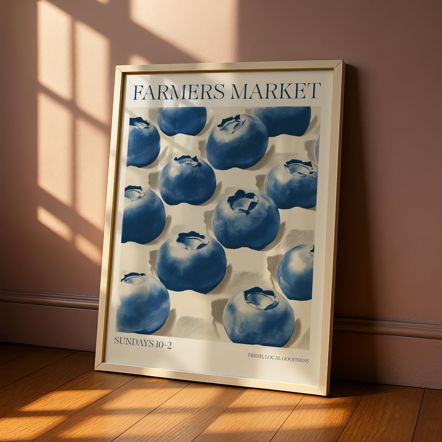 A framed poster of blueberries on a wall, with the text "Farmers Market" and "SUNDAYS 10-2" printed on it.