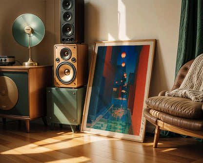 a living room with a large framed picture of a cityscape hanging on the wall, a brown leather chair, a wooden side table with a lamp, and a stack of speakers on the floor.