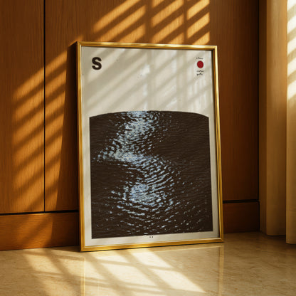 a framed artwork depicting a black and white abstract design with a wave-like pattern.