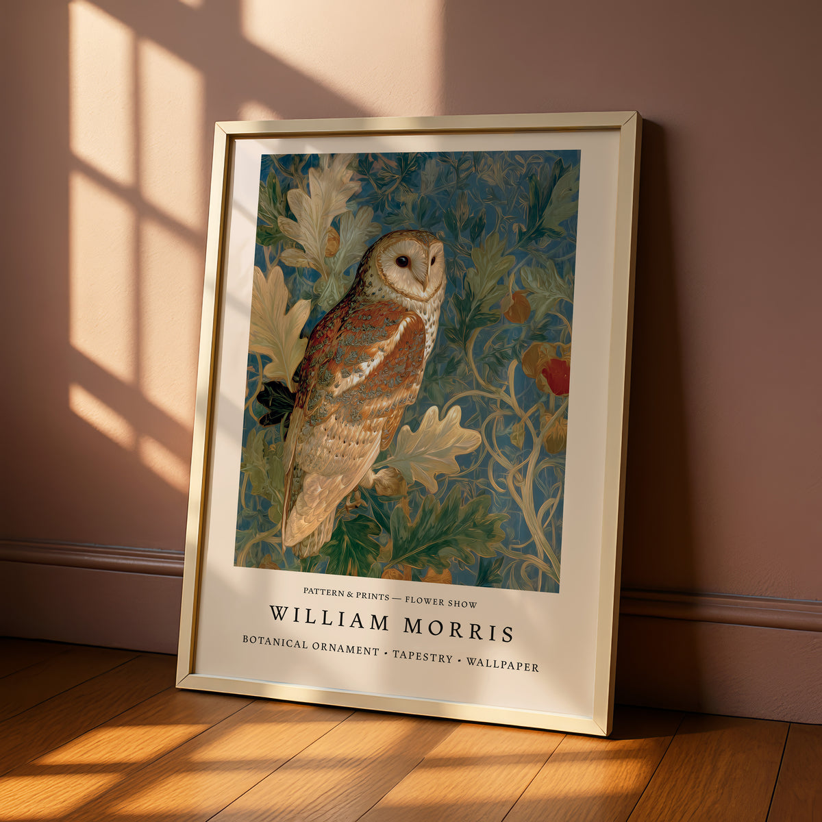 A framed print of a painting of a brown owl perched on a branch with leaves and flowers, displayed on a wooden floor against a pink wall.