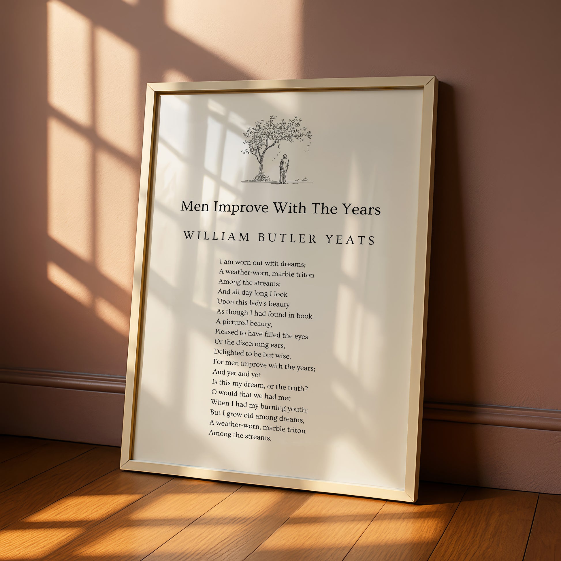 a framed poem titled "Men Improve With The Years" by William Butler Yeats, which is placed on a wooden floor against a wall.