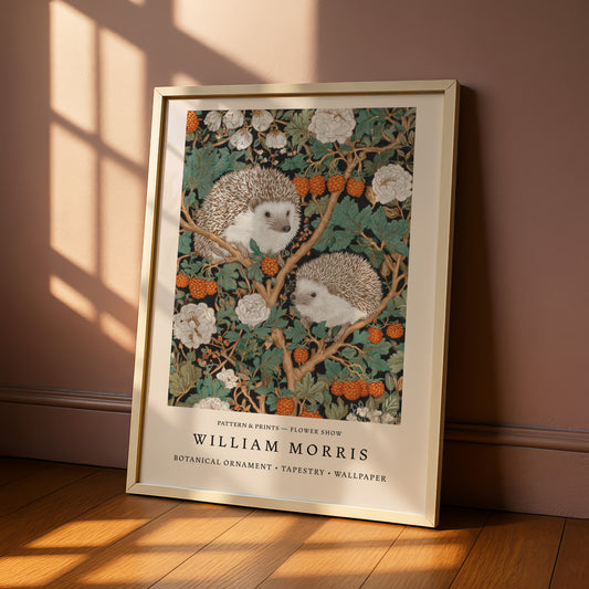 A framed print of a painting depicting two hedgehogs sitting on a branch with flowers and berries.