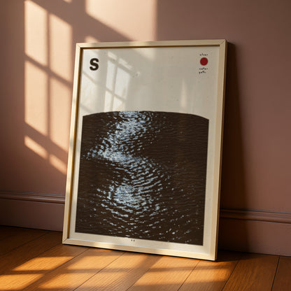 a framed artwork depicting a dark, wavy pattern on a white background, with a red dot in the top right corner.