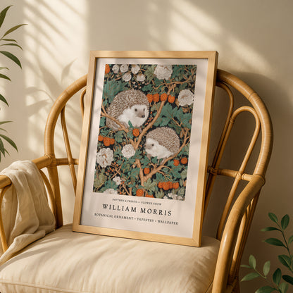 A framed print of a painting of two hedgehogs sitting in a floral arrangement is displayed on a wooden chair.