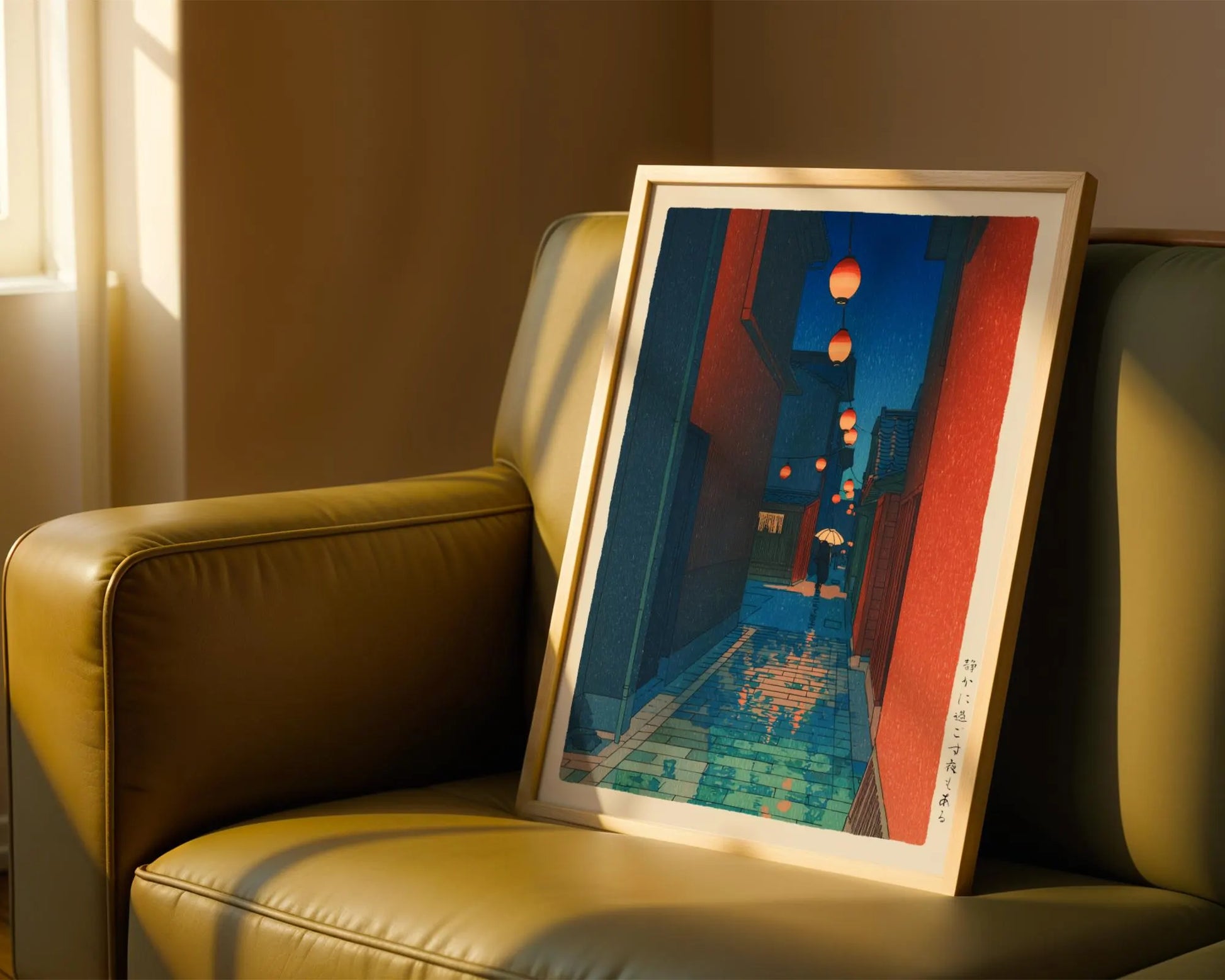 a framed artwork depicting a colorful alleyway at night, with lanterns hanging from the buildings and a reflection of the scene in the water below.