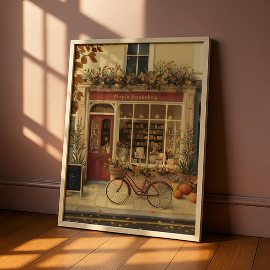 A framed illustration depicting a charming bookshop with a bicycle parked in front, surrounded by autumn decorations and a cozy atmosphere.