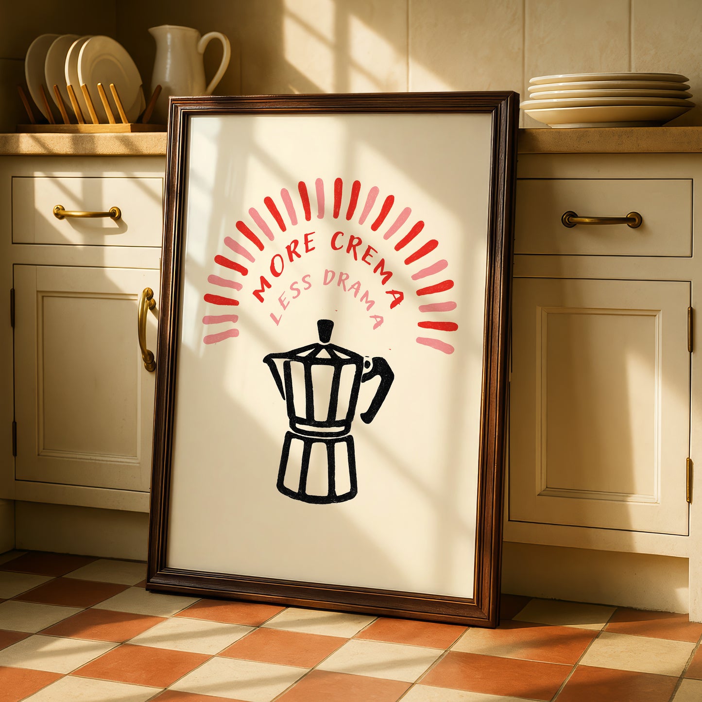 a framed poster with a black silhouette of a coffee maker and the text "MORE CREMA LESS DRAMA" in bold red and white letters.
